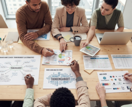 People reviewing brand strategy worksheets and design concepts together